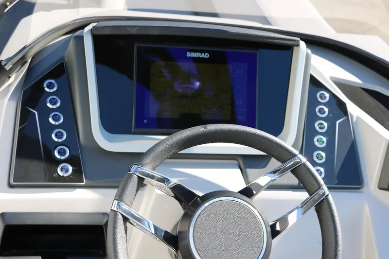Slide: The Image of 2024 Sylvan G5 CLZ DC boat dashboard with Simrad navigation system and steering wheel. - 38