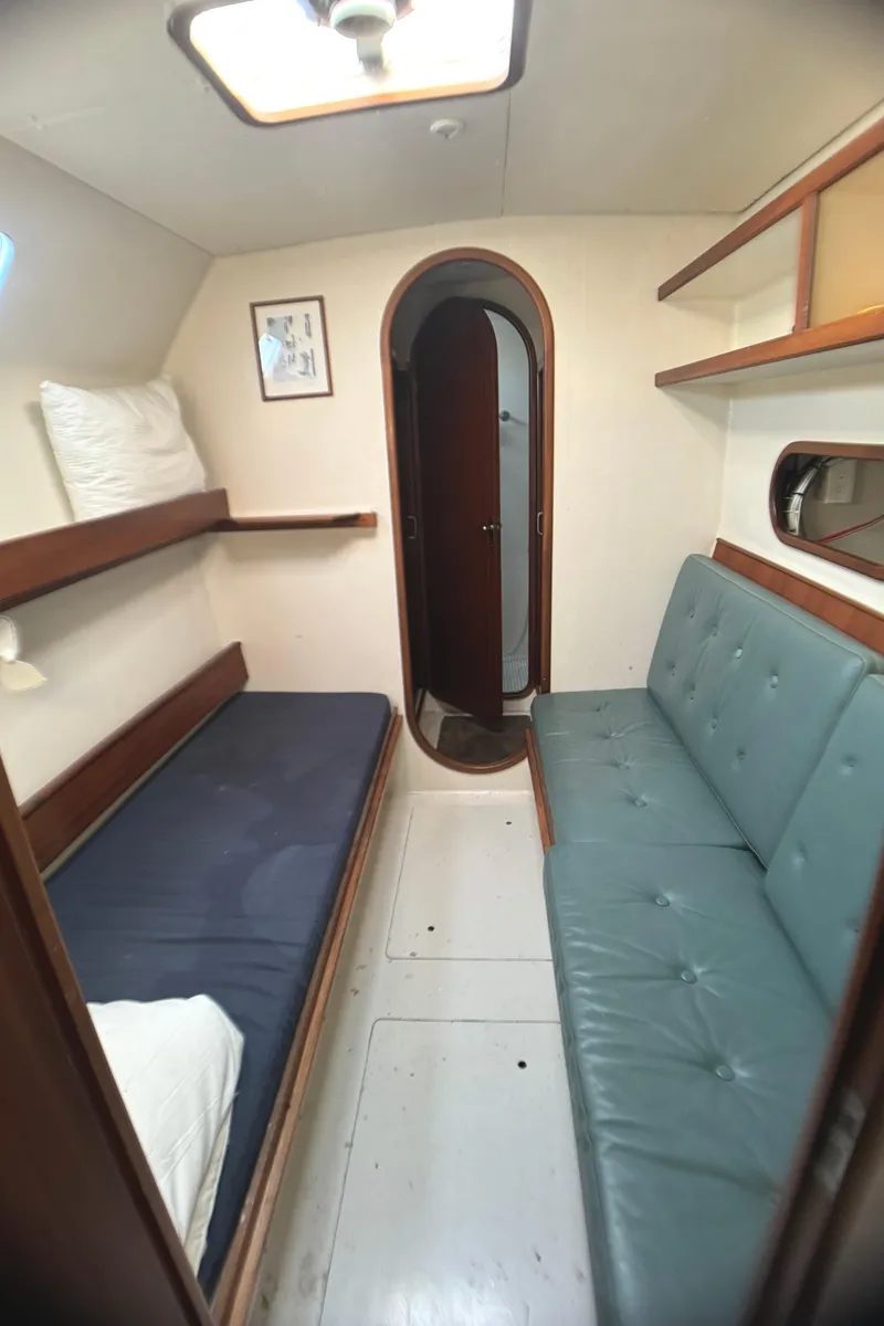 Slide: The Image of Interior of 1998 Catamaran Vision 51 with cozy seating and sleeping area. - 14