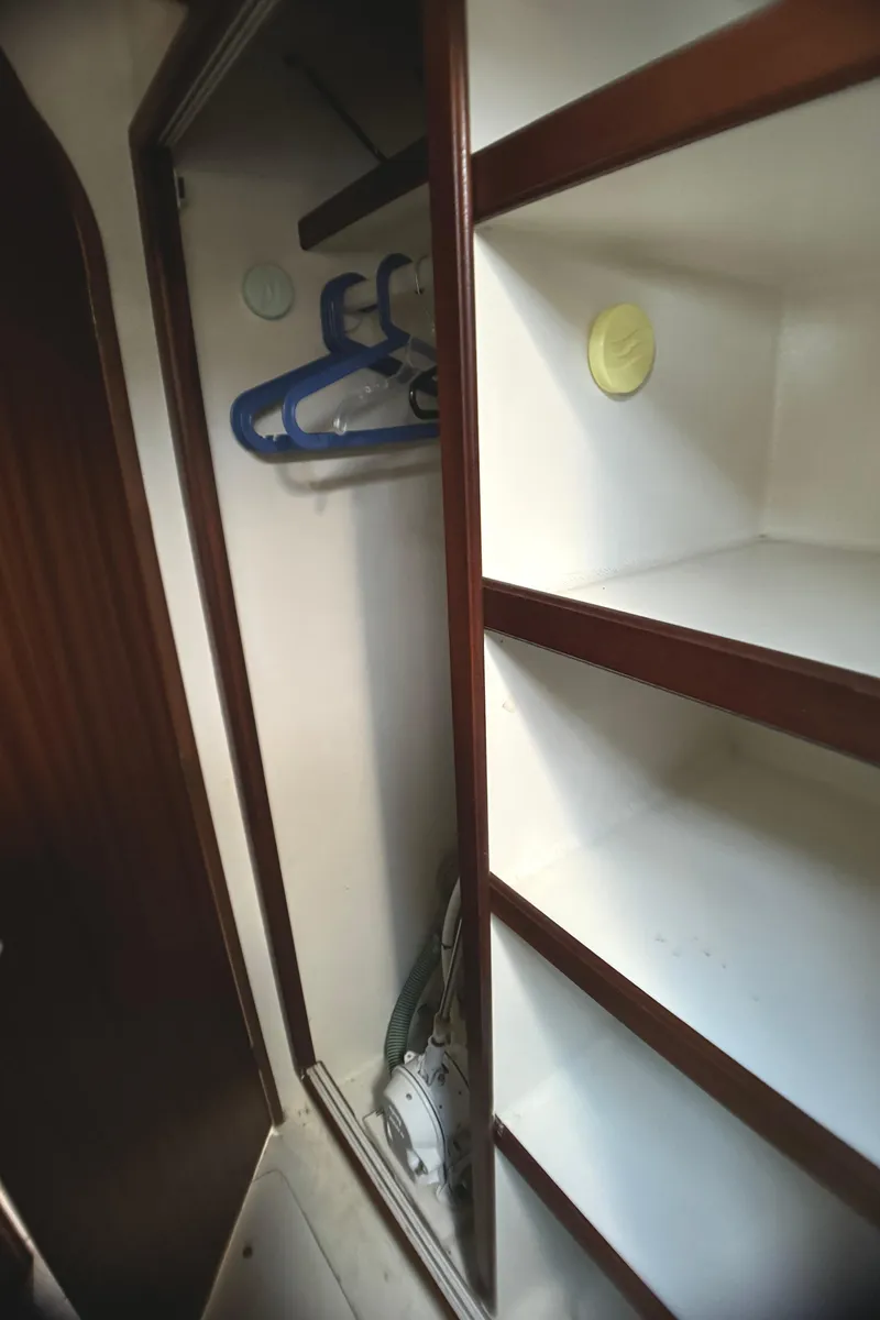 Slide: The Image of Interior closet of 1998 Catamaran Vision 51 with hangers and shelves. - 15