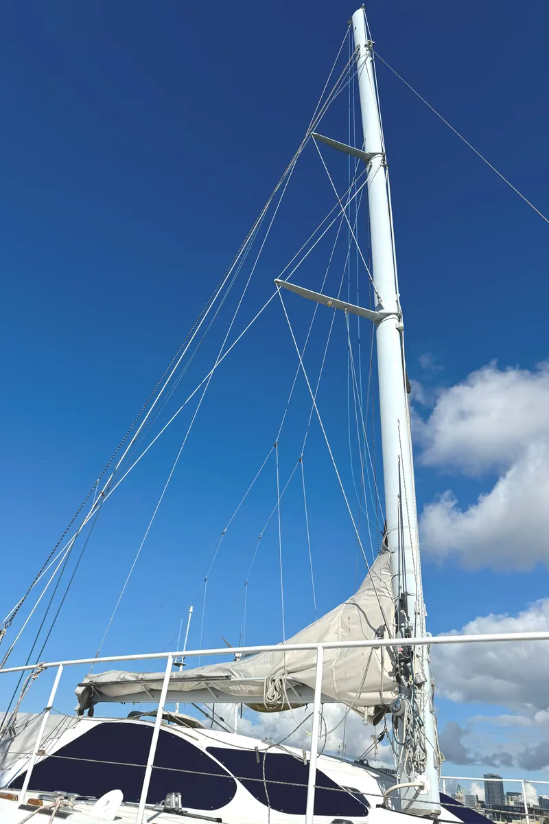 Slide: The Image of Sailing catamaran Vision 51, 1998 model, with tall mast against blue sky. - 24