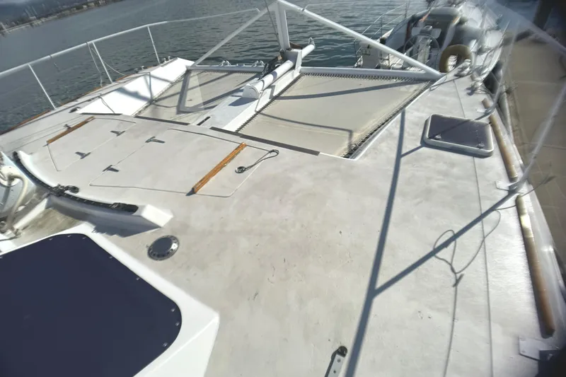Slide: The Image of Deck view of a 1998 Catamaran Vision 51, featuring spacious layout and netting. - 25
