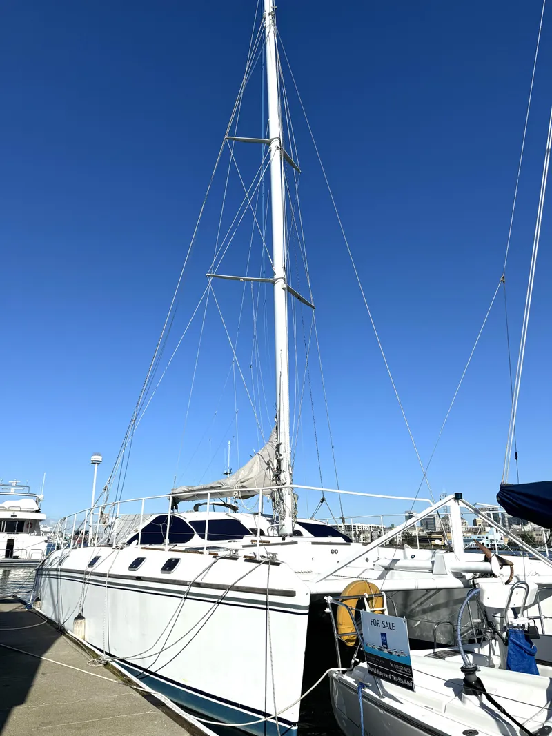 Slide: The Image of 1998 Catamaran Vision 51 docked under clear blue sky. - 26
