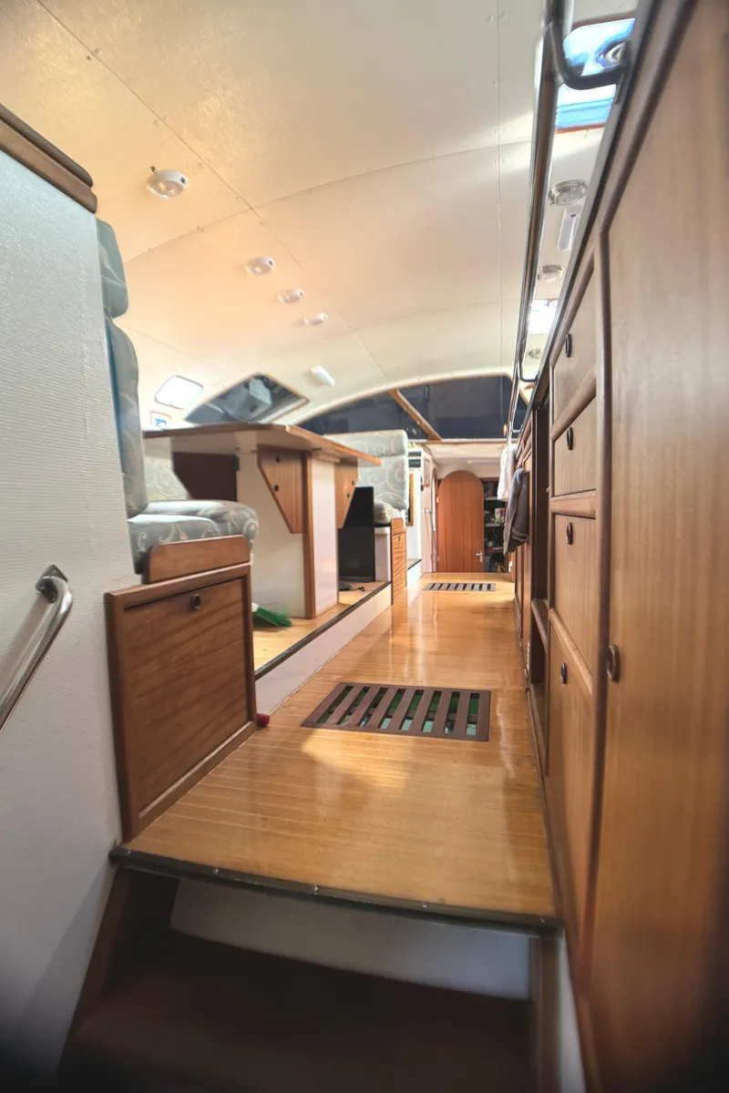 Slide: The Image of Interior of 1998 Catamaran Vision 51, featuring wooden cabinetry and modern design. - 3