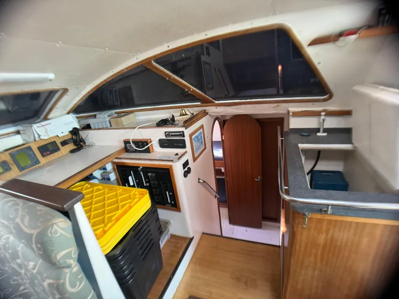 Slide: The Image of Interior of 1998 Catamaran Vision 51, featuring navigation equipment and compact kitchen area. - 5