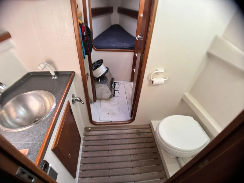 Slide: The Image of 1998 Catamaran Vision 51 bathroom interior with sink, toilet, and cabin view. - 8