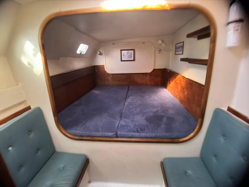 Slide: The Image of Interior cabin of 1998 Catamaran Vision 51 with cozy seating and spacious bed. - 9