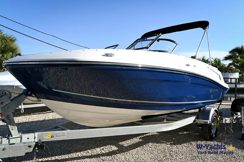 The Image of 2024 Bayliner VR5 boat on a trailer, blue and white exterior. - 0