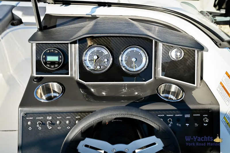 Slide: The Image of 2024 Bayliner VR5 boat dashboard with gauges and controls. - 10