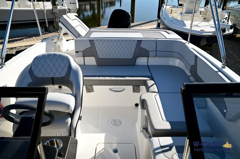 Slide: The Image of 2024 Bayliner VR5 boat interior with cushioned seating and steering wheel. - 14
