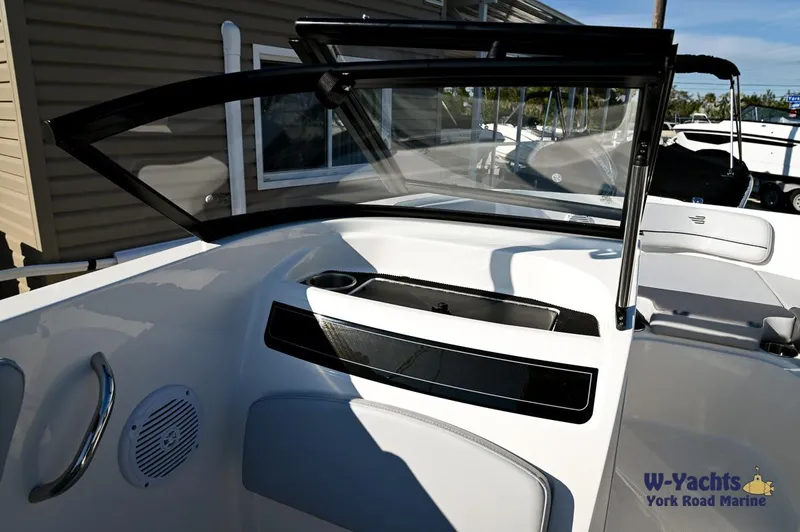 Slide: The Image of 2024 Bayliner VR5 boat interior with open windshield and seating area. - 16