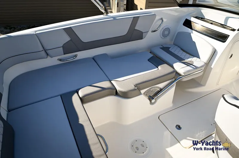 Slide: The Image of 2024 Bayliner VR5 boat interior with cushioned seating and storage compartments. - 17