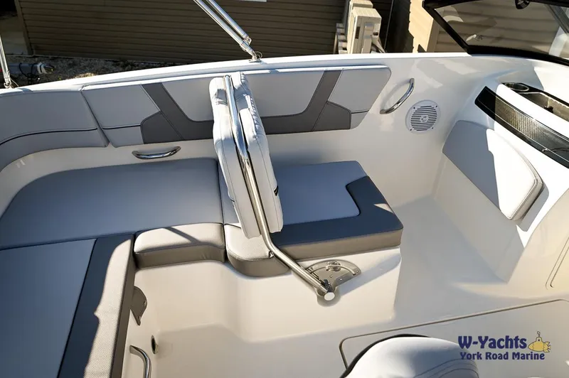 Slide: The Image of 2024 Bayliner VR5 boat interior with gray and white seating. - 18
