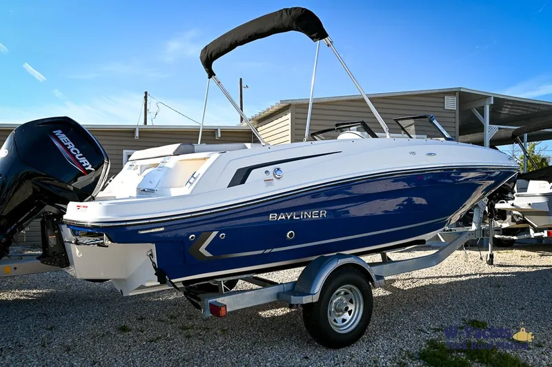 Slide: The Image of 2024 Bayliner VR5 boat on trailer, side view, blue and white exterior. - 2