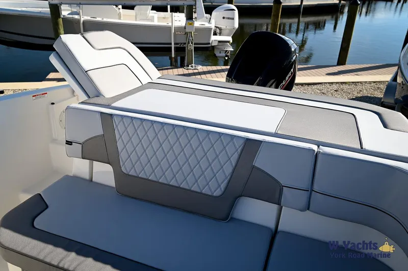 Slide: The Image of 2024 Bayliner VR5 boat interior with cushioned seating and diamond-patterned upholstery. - 22
