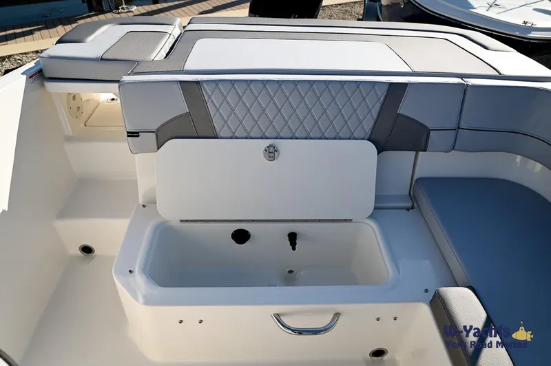Slide: The Image of 2024 Bayliner VR5 boat interior with storage compartment and cushioned seating. - 24