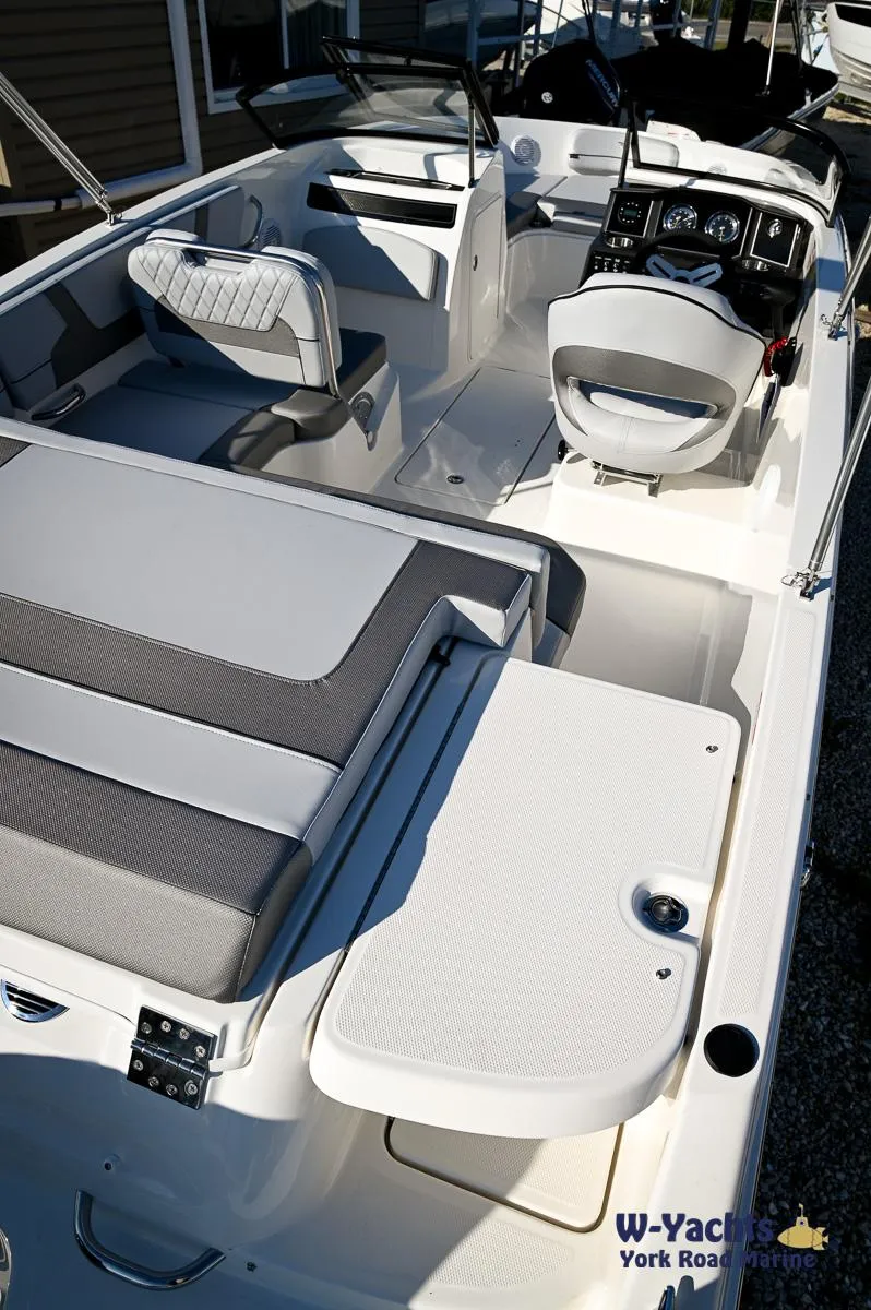 Slide: The Image of 2024 Bayliner VR5 boat interior with seating and control console. - 26