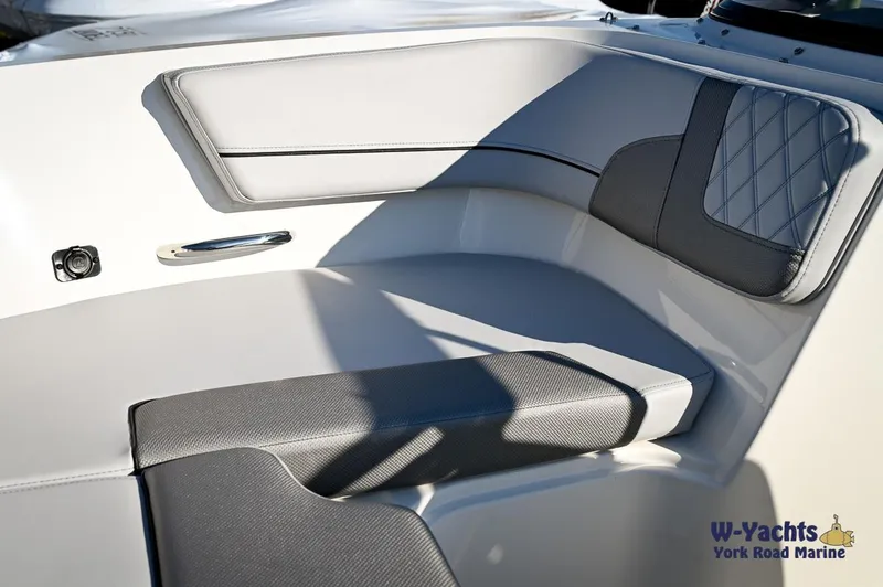 Slide: The Image of 2024 Bayliner VR5 boat interior seating with gray and white upholstery. - 5