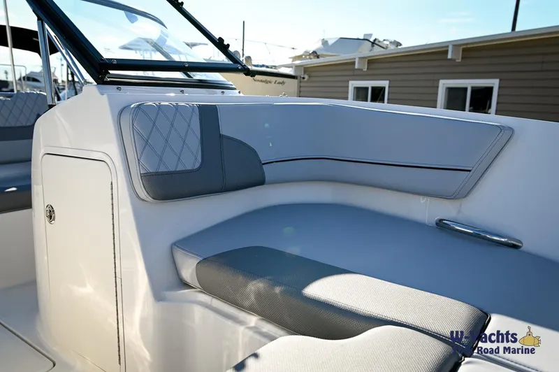 Slide: The Image of 2024 Bayliner VR5 boat interior seating with gray and white upholstery. - 6