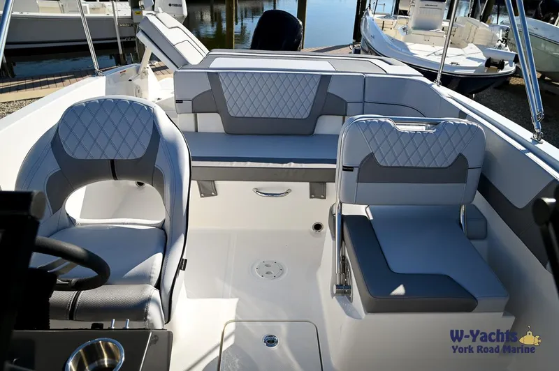 Slide: The Image of 2024 Bayliner VR5 boat interior with modern seating and steering wheel. - 7