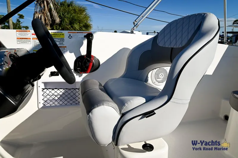 Slide: The Image of 2024 Bayliner VR5 boat cockpit with steering wheel and captain's chair. - 8