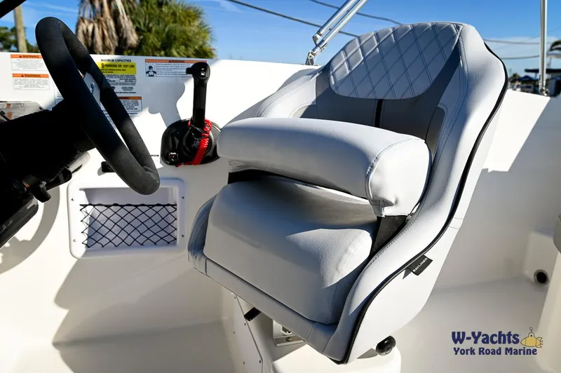 Slide: The Image of 2024 Bayliner VR5 boat captain's seat and steering wheel. - 9