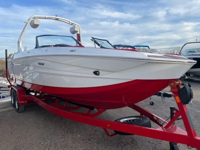 Slide: The Image of 2024 Supreme S240 boat with red and white design on trailer. - 3