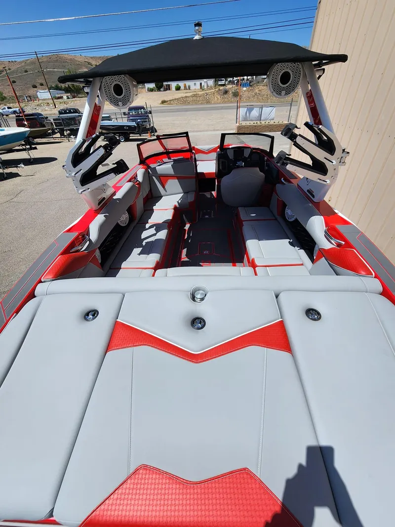 Slide: The Image of 2024 Supreme S240 boat with red and gray interior, black canopy, and modern design. - 6