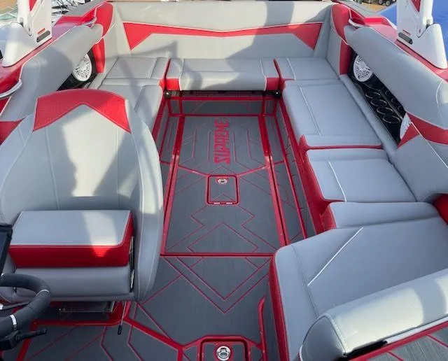 Slide: The Image of 2024 Supreme S240 boat interior with red and gray seating and flooring. - 9