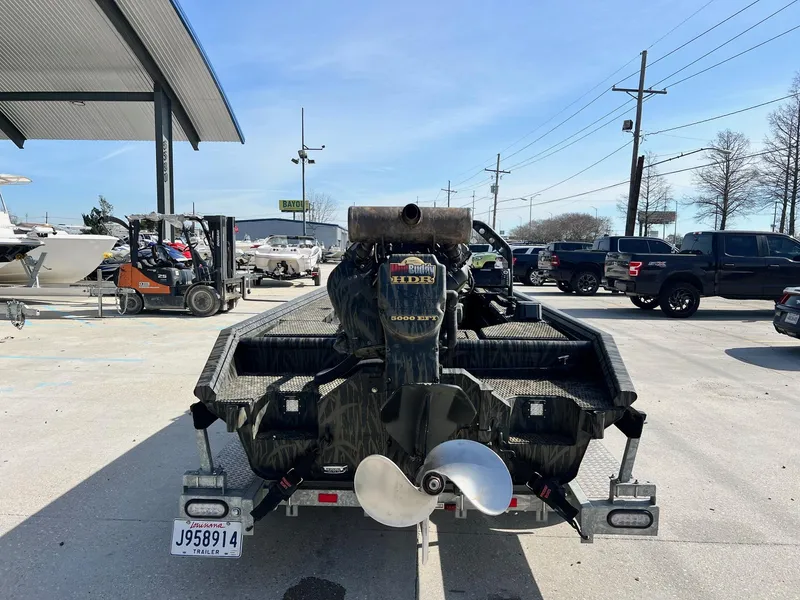 Slide: The Image of 2022 Prodigy 1751 boat with outboard motor in a parking lot. - 3