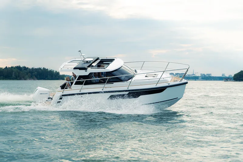 Slide: The Image of 2024 Aquador 250 HT cruising on open water, showcasing sleek design and performance. - 0