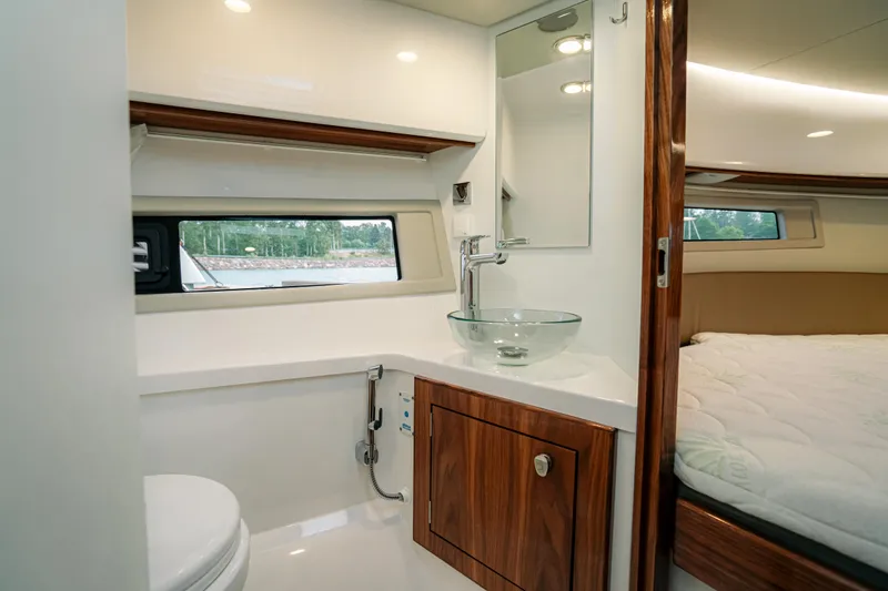 Slide: The Image of 2024 Aquador 250 HT interior with modern bathroom and cozy bedroom. - 10
