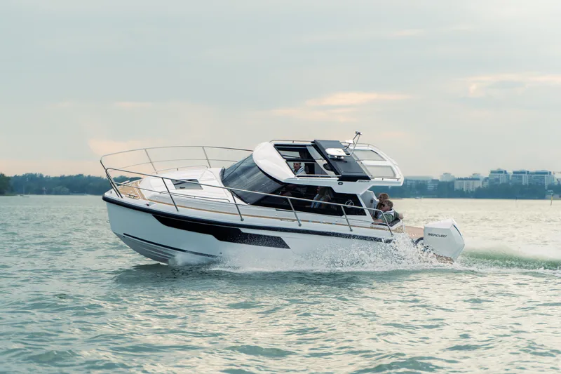 Slide: The Image of 2024 Aquador 250 HT boat cruising on open water, showcasing sleek design and performance. - 5