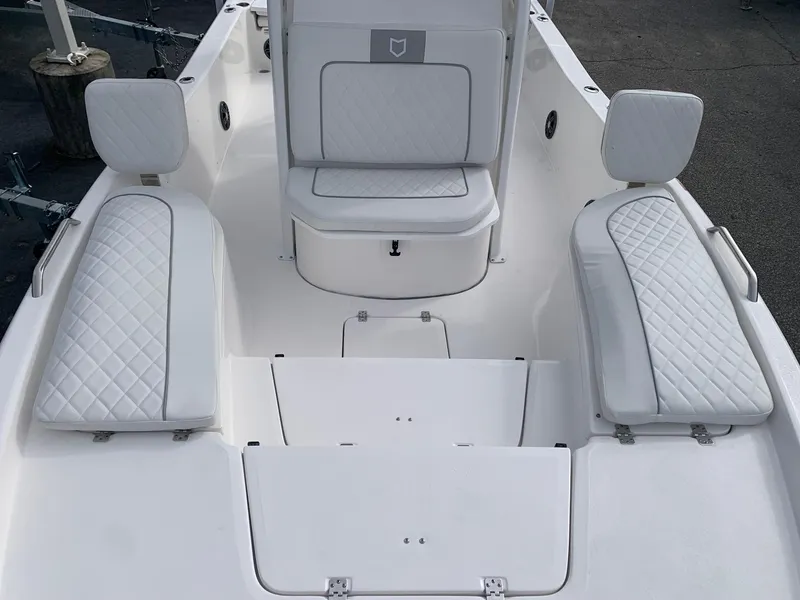Slide: The Image of 2024 Sea Fox 231 Bay Fox boat interior with white cushioned seating. - 9