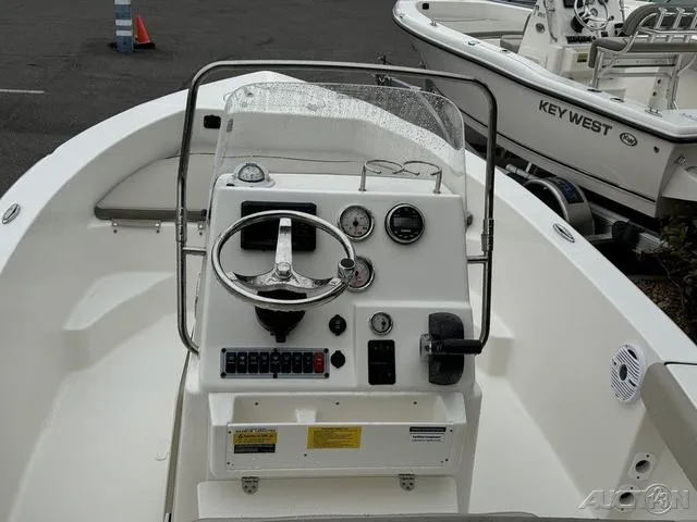 Slide: The Image of 2024 Key West 179 FS boat dashboard with steering wheel and gauges. - 18