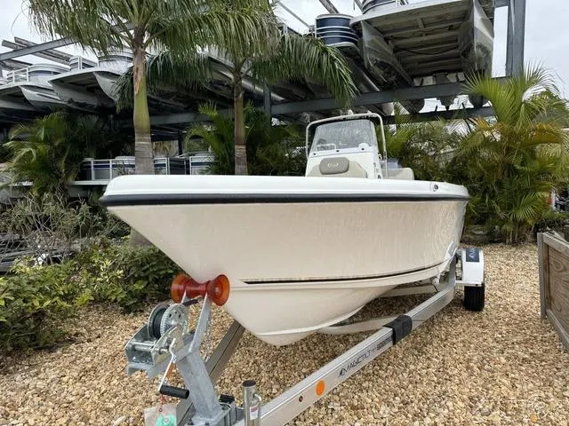 Slide: The Image of 2024 Key West 179 FS boat on trailer, surrounded by palm trees. - 4