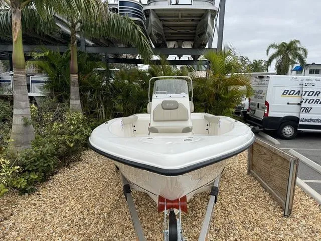 Slide: The Image of 2024 Key West 179 FS boat on trailer, parked outdoors near palm trees. - 6