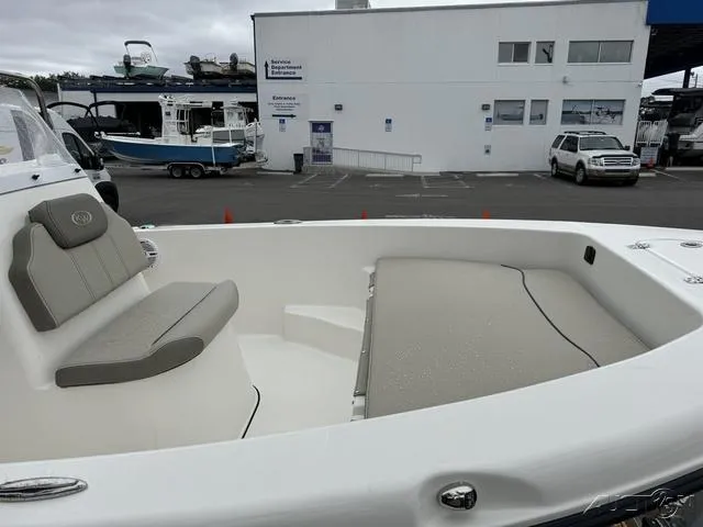 Slide: The Image of 2024 Key West 179 FS boat with Yamaha 90 engine, parked near palm trees. - 9