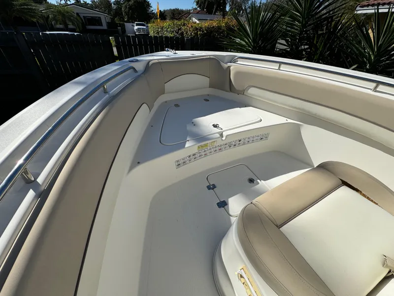 Slide: The Image of 2017 NauticStar 20 XS Offshore boat interior with cushioned seating and storage compartments. - 11