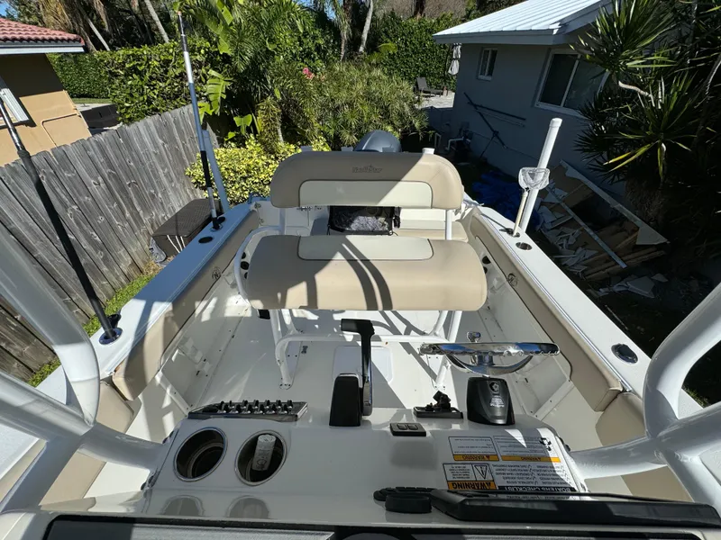 Slide: The Image of 2017 NauticStar 20 XS Offshore boat interior with beige seating and control panel. - 21