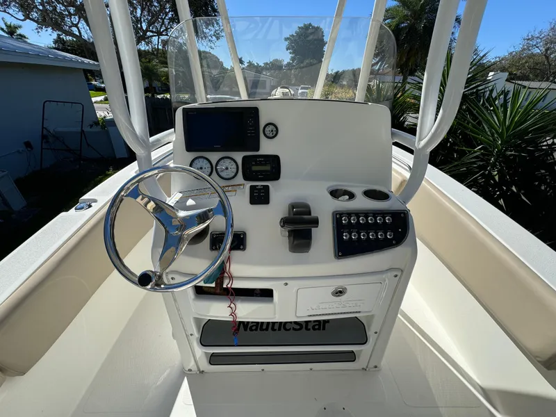 Slide: The Image of 2017 NauticStar 20 XS Offshore boat console with steering wheel and navigation controls. - 23