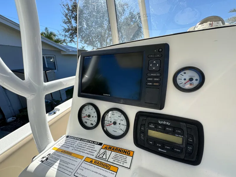 Slide: The Image of 2017 NauticStar 20 XS Offshore boat dashboard with gauges and navigation system. - 24