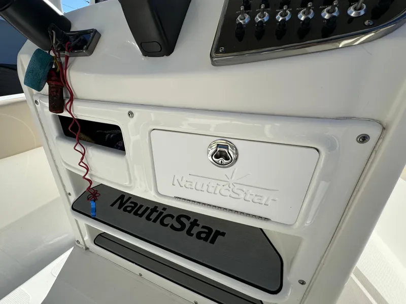 Slide: The Image of 2017 NauticStar 20 XS Offshore boat console with brand logo and control panel. - 27