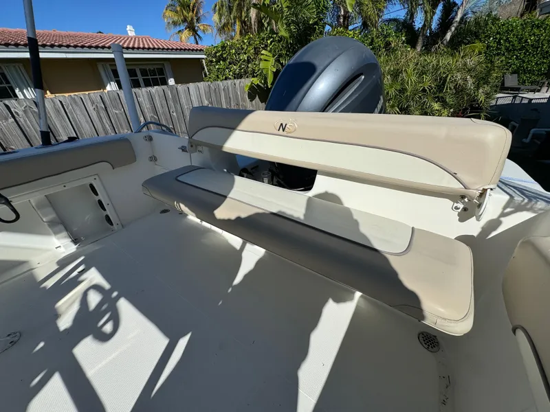 Slide: The Image of 2017 NauticStar 20 XS Offshore boat interior with seating and engine. - 29