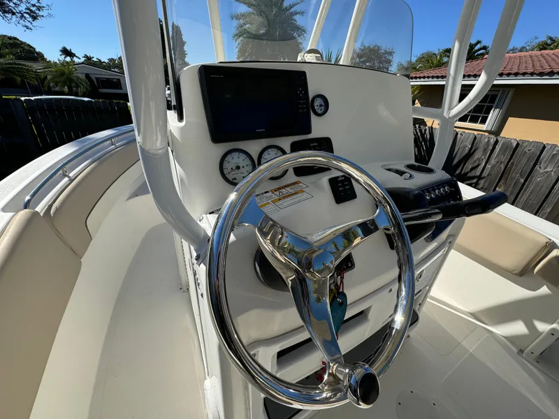 Slide: The Image of 2017 NauticStar 20 XS Offshore boat helm with steering wheel and navigation controls. - 31