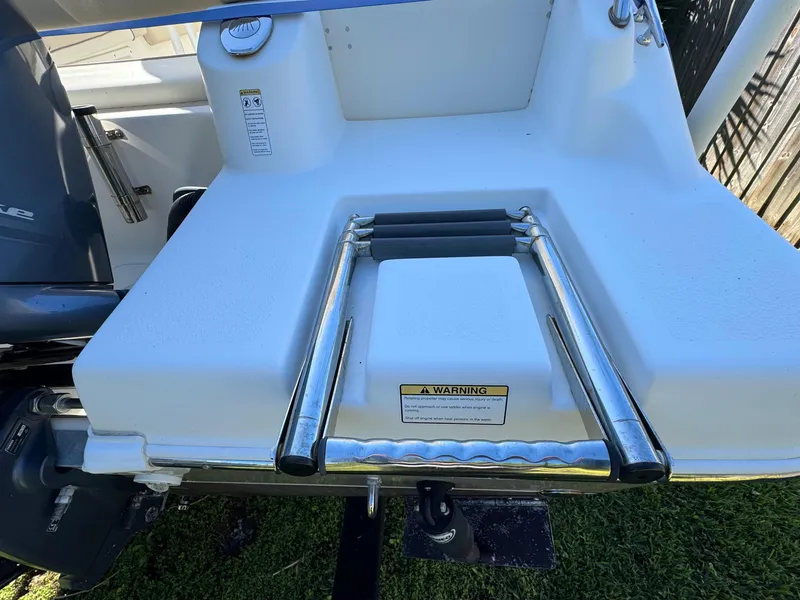 Slide: The Image of 2017 NauticStar 20 XS Offshore boat with a foldable swim ladder. - 8