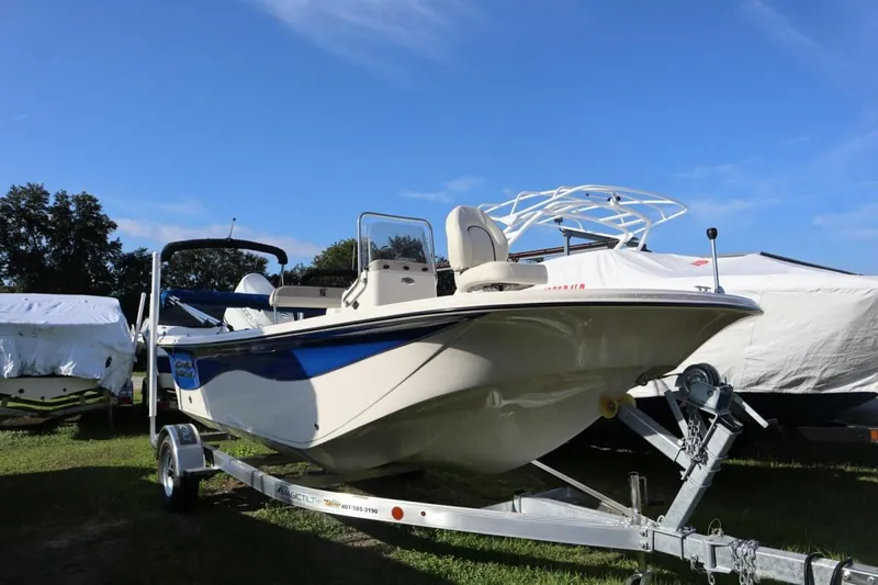 Slide: The Image of 2023 Carolina Skiff 17 LS boat on trailer under clear blue sky. - 3