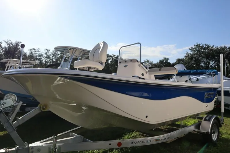 Slide: The Image of 2023 Carolina Skiff 17 LS boat on trailer, side view, blue and white design. - 5