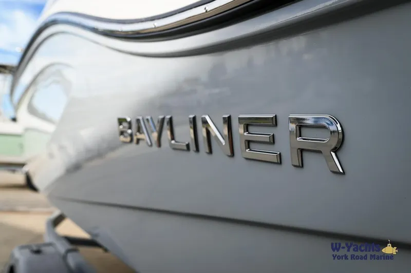 Slide: The Image of Close-up of 2024 Bayliner DX2000 boat logo on hull. - 2