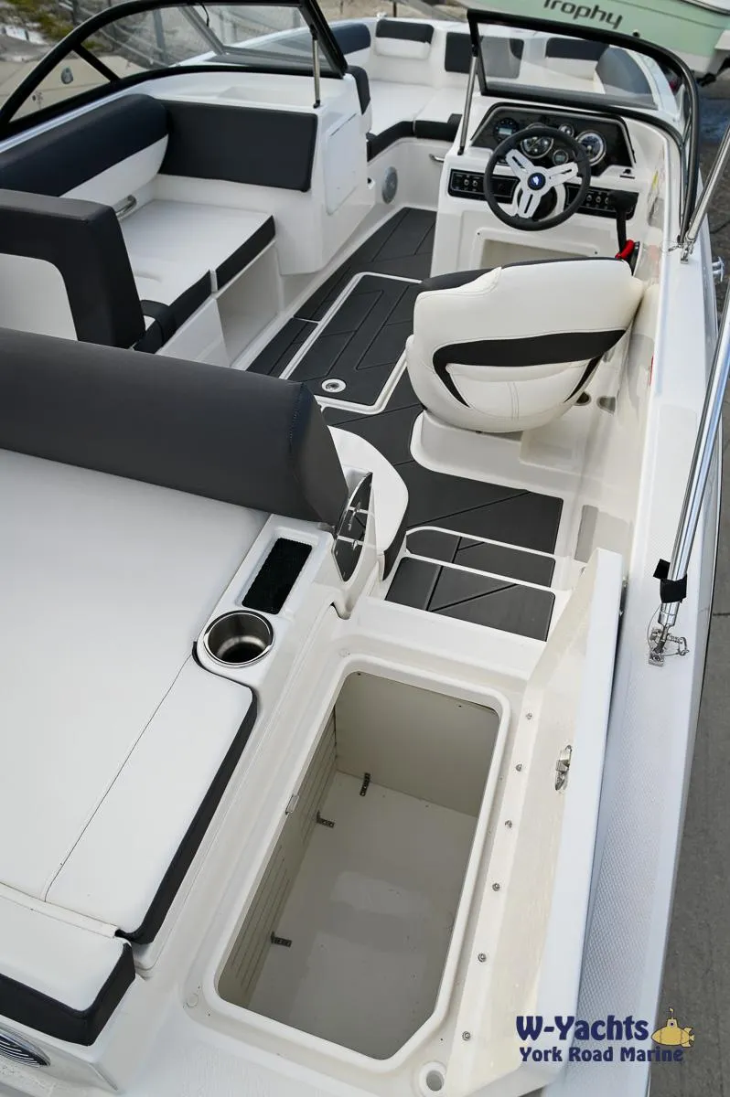 Slide: The Image of 2024 Bayliner DX2000 boat interior with seating and storage compartments. - 22