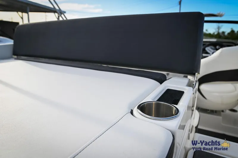 Slide: The Image of 2024 Bayliner DX2000 boat interior with cup holder and seating. - 26